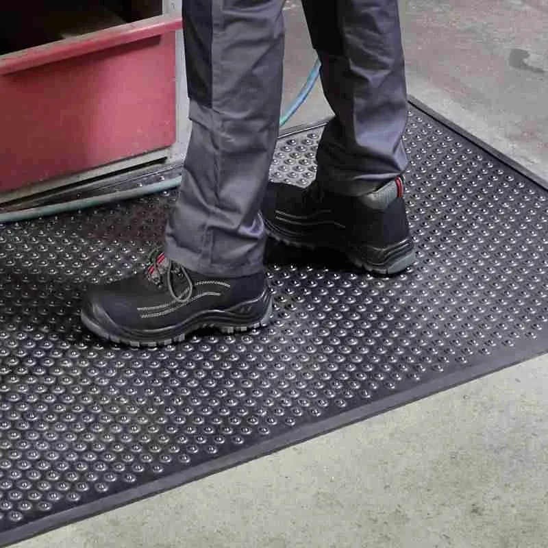 Anti-fatigue black rubber mat with a raised circular dome pattern.