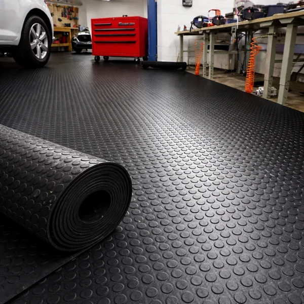 Black coin-grip rubber roll in a home garage.