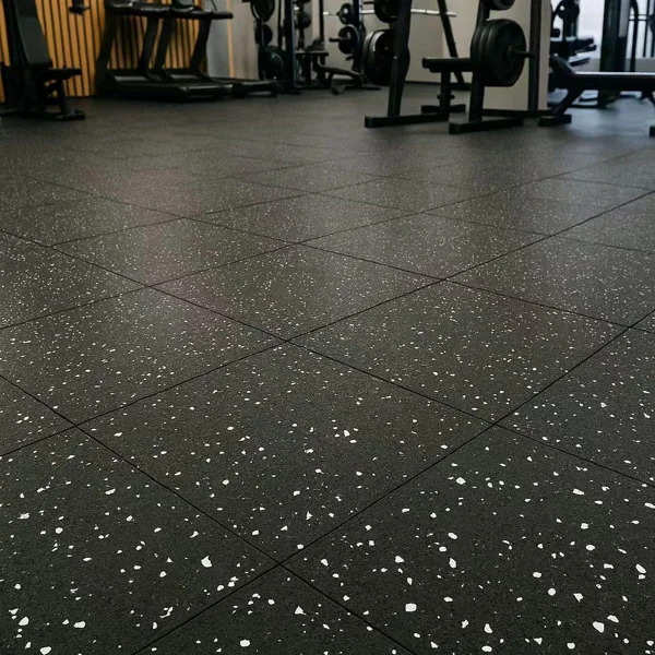Black speckled interlocking gym floor tiles.