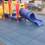 Blue and yellow slide structure on rubber safety mats