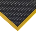 Close-up of black bubble mat with yellow safety border