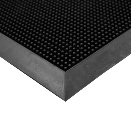 Close-up of black rubber pin doormat corner