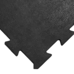 Close-up of black textured foam tile with puzzle edges