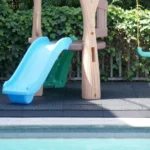 Close-up of rubber safety mats under a slide