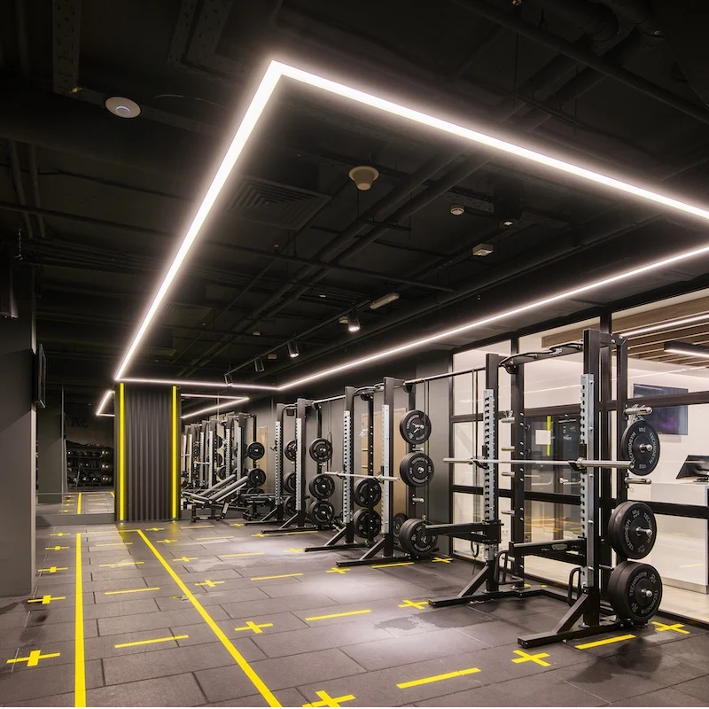 Large black rubber floor tiles with yellow crosshair functional markings.