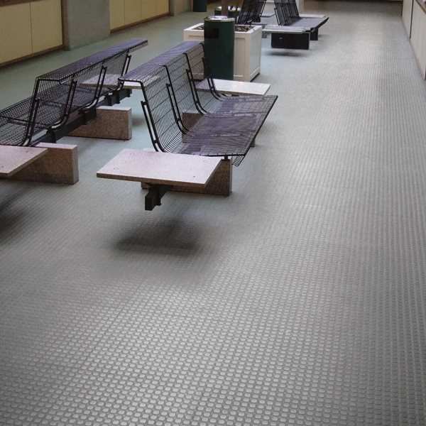 Light gray coin-texture flooring in a lobby.