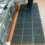 Long runner of anti-fatigue drainage mats in kitchen