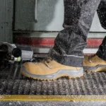 Person in work boots standing on bubble mat in workshop
