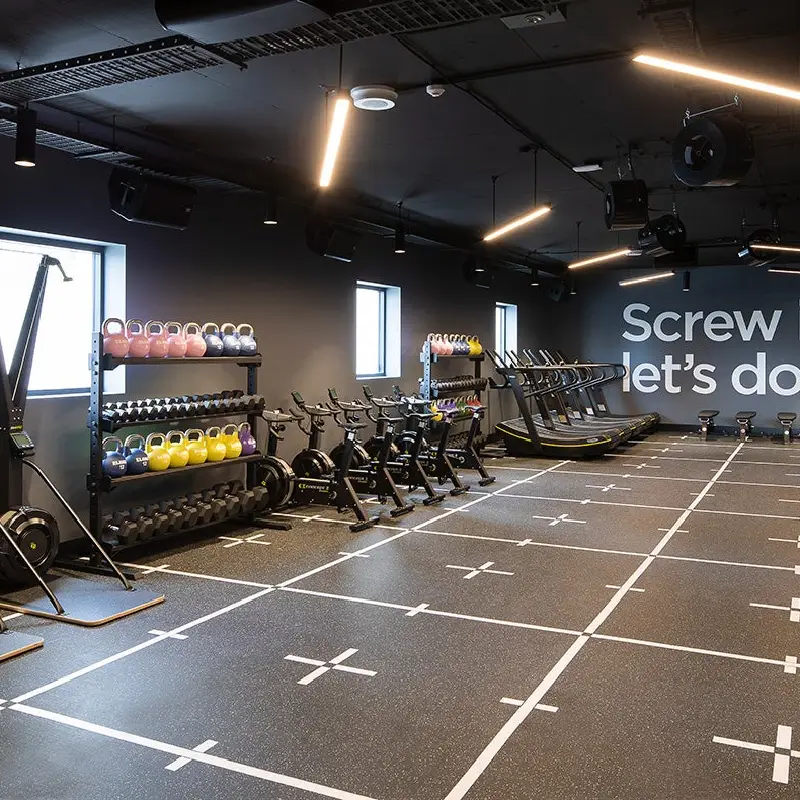 Speckled rubber gym floor with a white grid and crosshair markings.