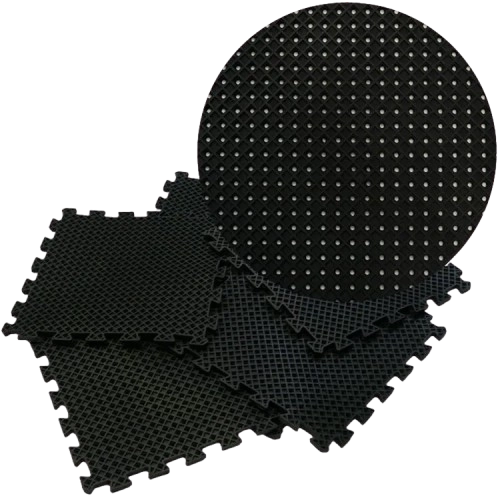 Stack of interlocking black drainage floor tiles