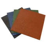 Stacked rubber floor tiles in red, green, blue, and black