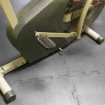 Stationary exercise bike on black foam gym flooring