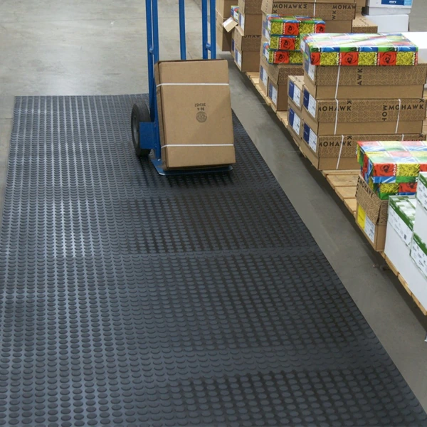 Studded rubber floor runner in a warehouse.