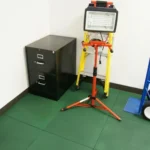 Utility light and cabinet on green rubber floor tiles