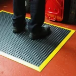 Worker standing on industrial bubble mat with yellow edge
