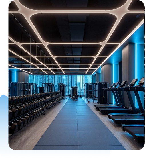 Modern gym with treadmills, weight racks, and blue lighting